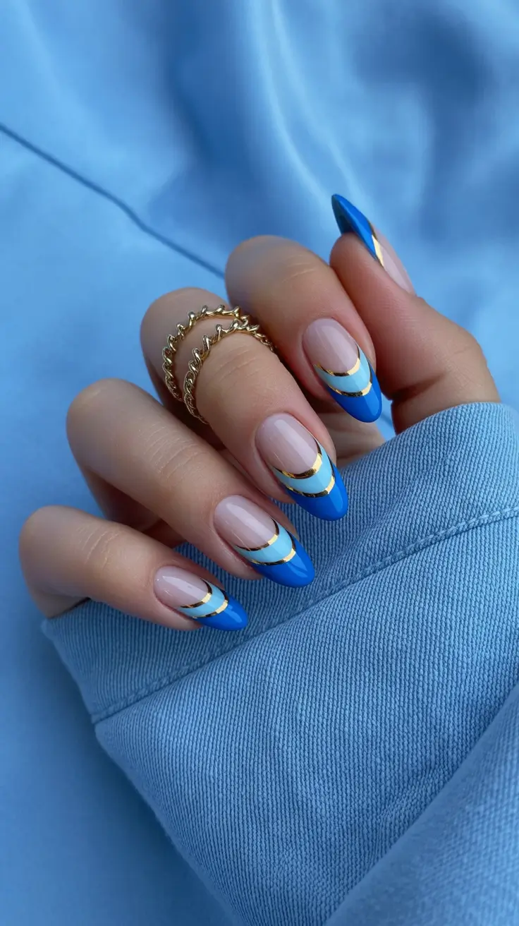 amazing spring almond nails 2026 Blue French Almond Nails With Gold Line Accents