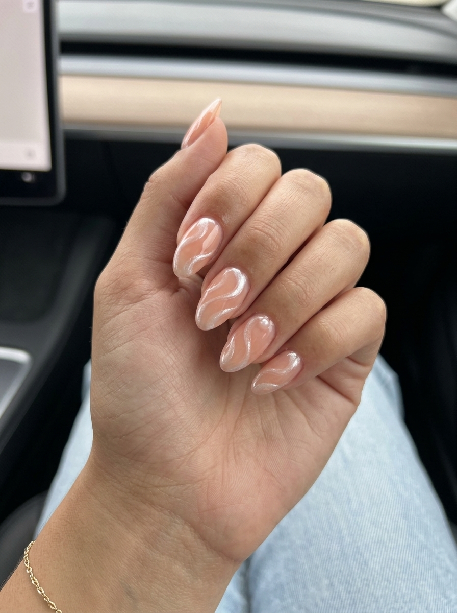 Dreamy Peach Swirls Nails: Soft peach jelly with pearlescent white swirls. Romantic for weddings & dates.