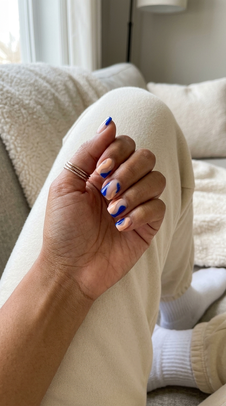 Artistic peach and cobalt blue abstract nails for casual chic. Colourful summer nails 2026.