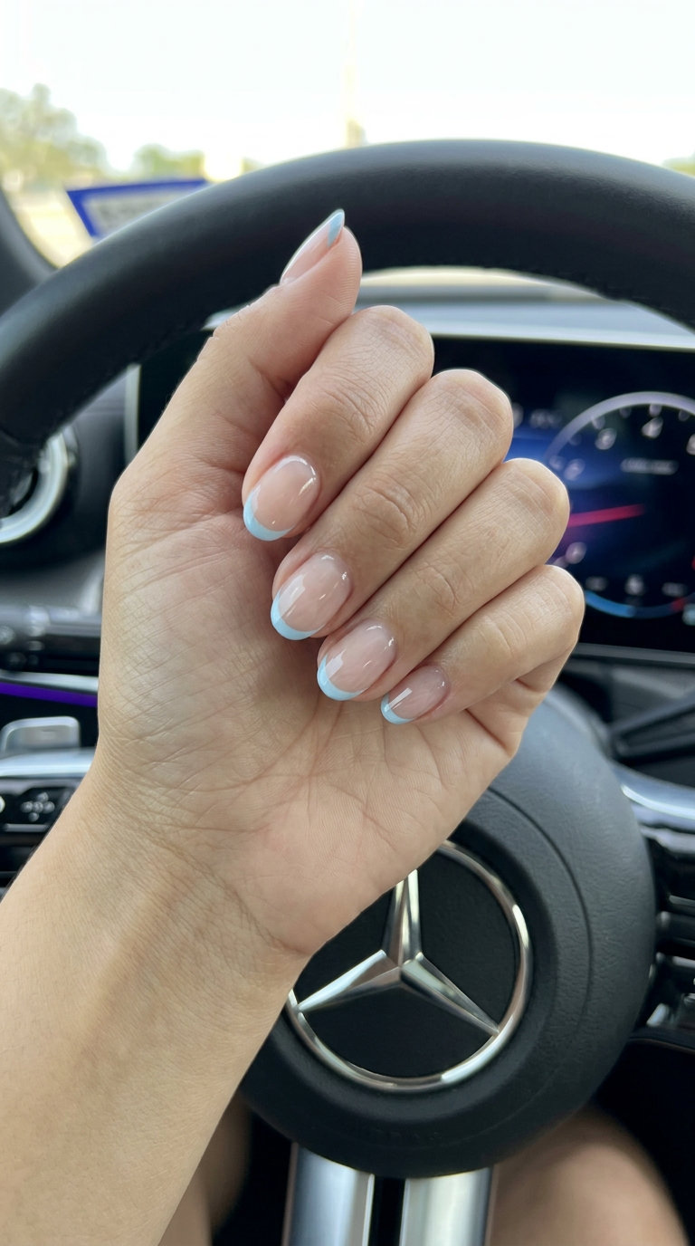 Short oval summer nails 2026: Sky Blue Micro French Accent - subtle blue tip.