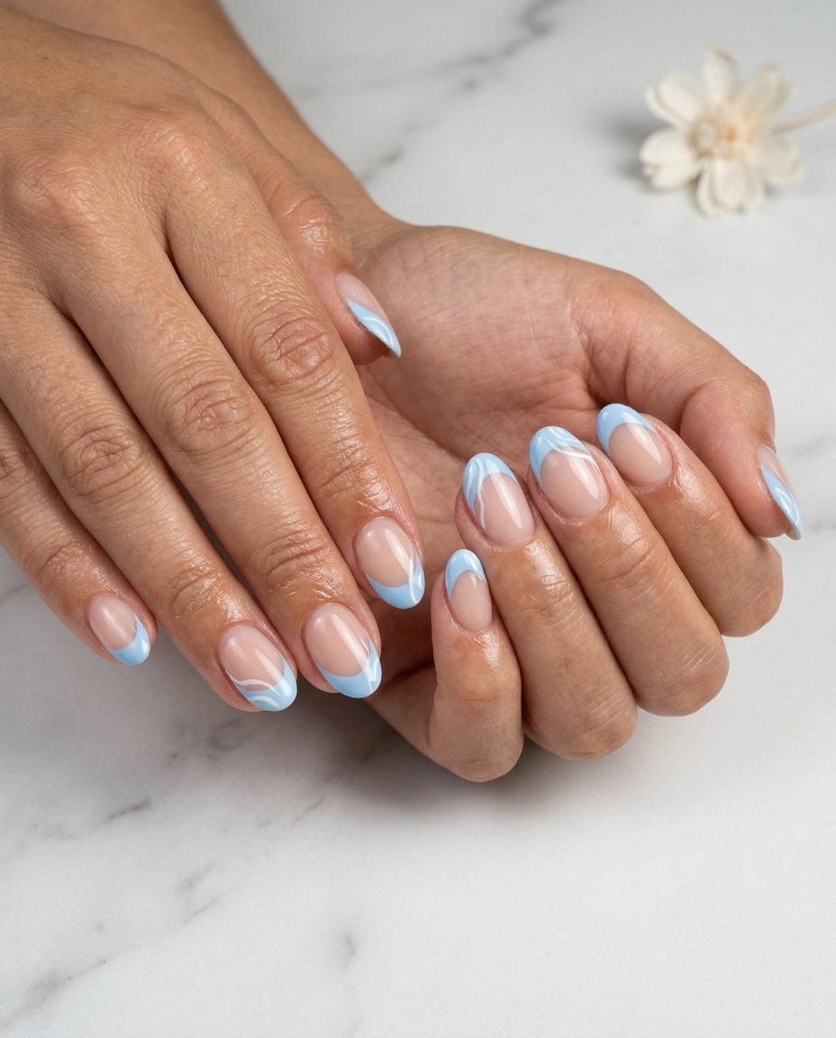 Short oval summer nails 2026: Sky blue french tips with white swirls. Perfect for vacation or summer parties.