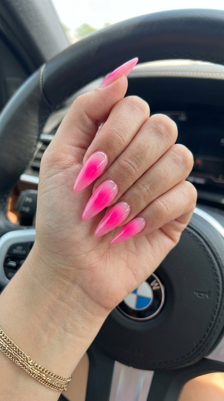 Neon pink aura gradient stiletto nails for a bold festival look. Stiletto summer nails 2026.
