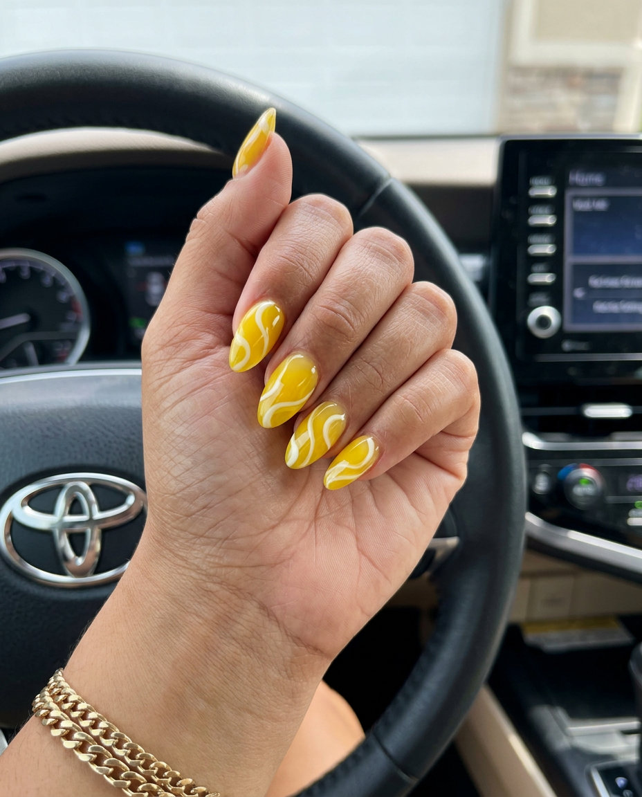 Summer acrylic nails 2026: Lemonade Swirl Almond with translucent yellow & creamy white swirls.