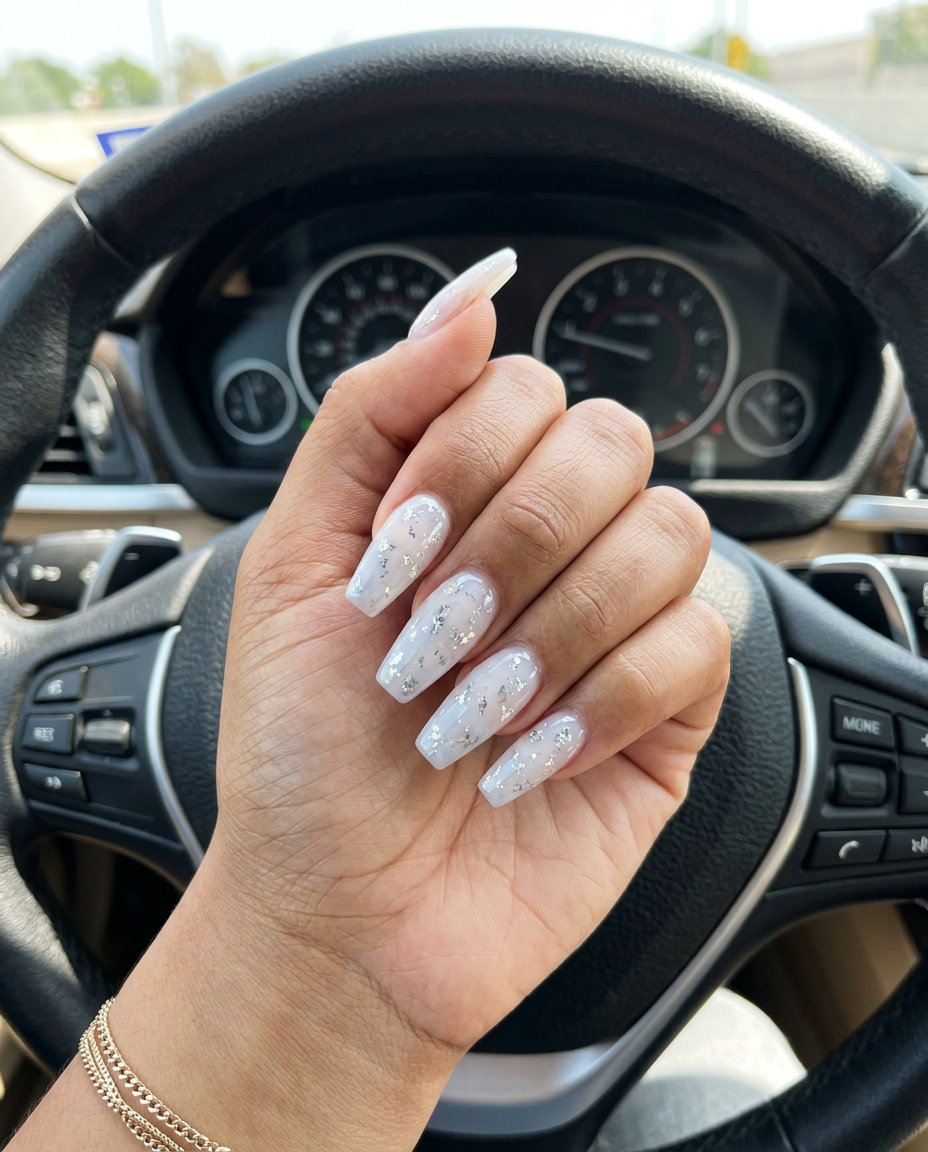 Cosmic foil coffin nails for summer holiday nails 2026. Edgy, celestial silver foil on sheer white.
