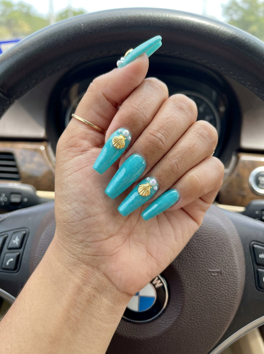 Ocean Charm Coffin summer holiday nails 2026: turquoise, shell charms, pearls, medium coffin shape.