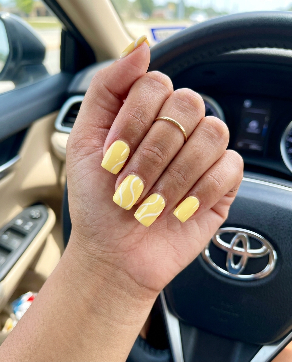 Artistic butter yellow swirls on medium square nails for summer nails square medium 2026. Sunny vacation vibes.